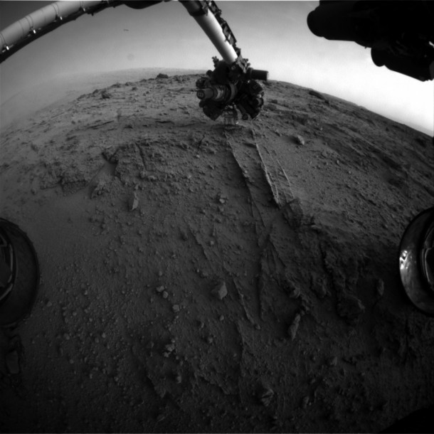 NASA's Mars rover Curiosity used a new technique, with added autonomy for the rover, in placement of the tool-bearing turret on its robotic arm during the 399th Martian day, or sol, of the mission. This image from the rover's front Hazard Avoidance Camera (Hazcam) on that sol shows the position of the turret during that process, with the Alpha Particle X-ray Spectrometer (APXS) instrument placed close to the target rock. Credit: NASA/JPL-Caltech NASA's Mars rover Curiosity used a new technique, with added autonomy for the rover, in placement of the tool-bearing turret on its robotic arm during the 399th Martian day, or sol, of the mission. This image from the rover's front Hazard Avoidance Camera (Hazcam) on that sol shows the position of the turret during that process, with the Alpha Particle X-ray Spectrometer (APXS) instrument placed close to the target rock. Credit: NASA/JPL-Caltech