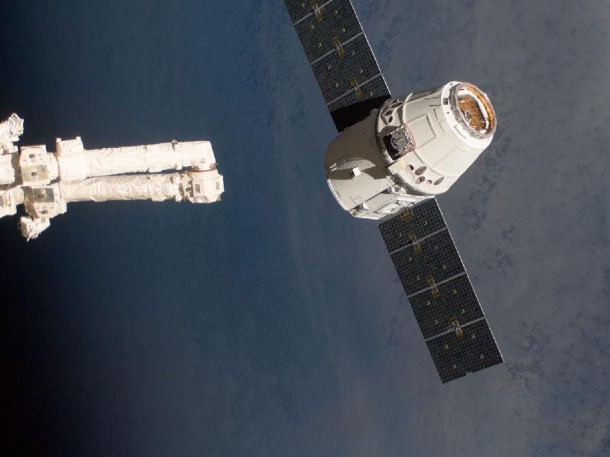 The SpaceX Dragon commercial cargo craft, as it is about to be grappled by the Canadarm2 robotic arm at the International Space Station in May 2012. The SpaceX Dragon commercial cargo craft, as it is about to be grappled by the Canadarm2 robotic arm at the International Space Station in May 2012.