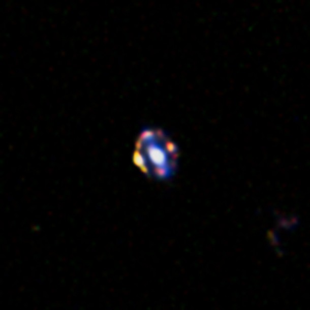 This picture from the NASA/ESA Hubble Space Telescope shows the most distant gravitational lens yet discovered. The glow at the centre of this picture is the central regions of a normal galaxy. By chance it is precisely aligned with a much more remote, young star-forming galaxy. The light from the more distant object is bent around the nearer object by its strong graviational pull to form a ring of multiple images. The chance of finding such an exact alignment is very small, suggesting that there may be more star-forming galaxies in the early Universe than expected. Credit: NASA/ESA/A. van der Wel This picture from the NASA/ESA Hubble Space Telescope shows the most distant gravitational lens yet discovered. The glow at the centre of this picture is the central regions of a normal galaxy. By chance it is precisely aligned with a much more remote, young star-forming galaxy. The light from the more distant object is bent around the nearer object by its strong graviational pull to form a ring of multiple images. The chance of finding such an exact alignment is very small, suggesting that there may be more star-forming galaxies in the early Universe than expected. Credit: NASA/ESA/A. van der Wel