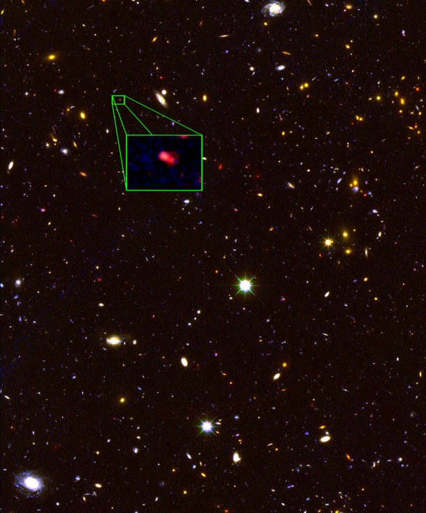 This image from the Hubble Space Telescope CANDELS survey highlights the most distant galaxy in the universe with a definitively measured distance, dubbed z8_GND_5296. The galaxy's red color alerted astronomers that it was likely extremely far away, and thus seen at an early time after the Big Bang. A team of astronomers measured the exact distance using the Keck I telescope with the new MOSFIRE spectrograph. They found that this galaxy is seen at about 700 million years after the Big Bang, when the universe was just 5 percent of its current age of 13.8 billion years. Credit: NASA, ESA, V. Tilvi (Texas A&M University), S. Finkelstein (University of Texas, Austin), and C. Papovich (Texas A&M University) This image from the Hubble Space Telescope CANDELS survey highlights the most distant galaxy in the universe with a definitively measured distance, dubbed z8_GND_5296. The galaxy's red color alerted astronomers that it was likely extremely far away, and thus seen at an early time after the Big Bang. A team of astronomers measured the exact distance using the Keck I telescope with the new MOSFIRE spectrograph. They found that this galaxy is seen at about 700 million years after the Big Bang, when the universe was just 5 percent of its current age of 13.8 billion years. Credit: NASA, ESA, V. Tilvi (Texas A&M University), S. Finkelstein (University of Texas, Austin), and C. Papovich (Texas A&M University)