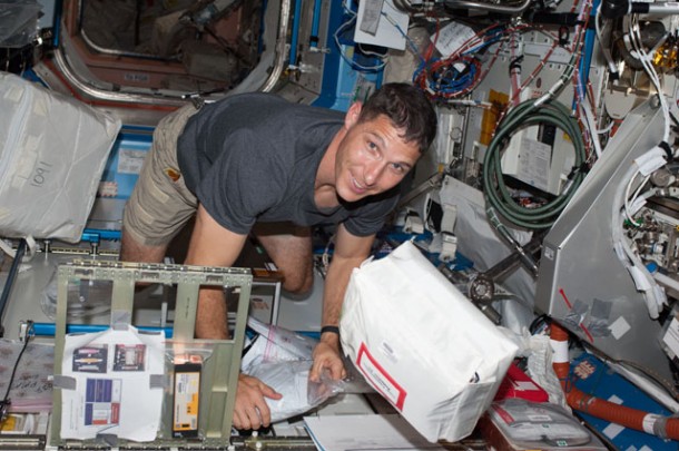 NASA astronaut Michael Hopkins, Expedition 37 flight engineer, stows items in a locker in the Destiny laboratory of the International Space Station. Image Credit: NASA NASA astronaut Michael Hopkins, Expedition 37 flight engineer, stows items in a locker in the Destiny laboratory of the International Space Station. Image Credit: NASA