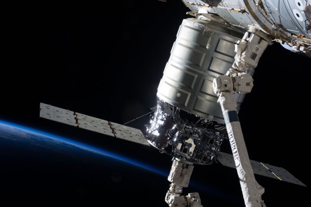 Attached to the Harmony node, the first Cygnus commercial cargo spacecraft built by Orbital Sciences Corp., in the grasp of the Canadarm2, is photographed by an Expedition 37 crew member on the International Space Station. Image Credit: NASA Attached to the Harmony node, the first Cygnus commercial cargo spacecraft built by Orbital Sciences Corp., in the grasp of the Canadarm2, is photographed by an Expedition 37 crew member on the International Space Station. Image Credit: NASA