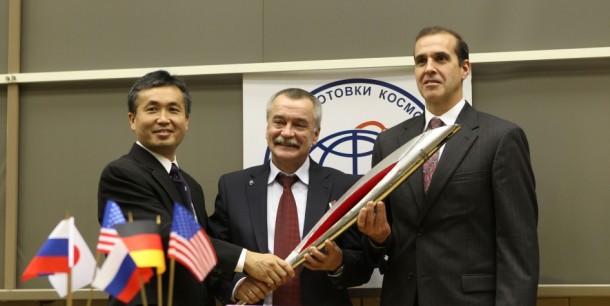 Soyuz Commander Mikhail Tyurin (center) and NASA Flight Engineer Rick Mastracchio pose with a model of the Olympic torch following an Expedition 38 crew news conference Oct. 22, 2013. Image Credit: NASA Soyuz Commander Mikhail Tyurin (center) and NASA Flight Engineer Rick Mastracchio pose with a model of the Olympic torch following an Expedition 38 crew news conference Oct. 22, 2013. Image Credit: NASA