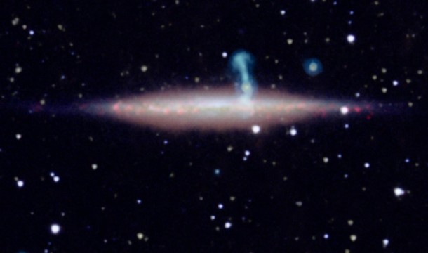 The edge-on spiral galaxy UGC 10288 appeared to be a single object in previous observations. However, new detailed radio data from the NRAO's Jansky Very Large Array (VLA) revealed that the large perpendicular extension of UGC 10288's halo (blue) is really a distant background galaxy with radio jets. Image credit: VLA/NASA/JPL-Caltech/SDSS/NOAO/University of Manitoba The edge-on spiral galaxy UGC 10288 appeared to be a single object in previous observations. However, new detailed radio data from the NRAO's Jansky Very Large Array (VLA) revealed that the large perpendicular extension of UGC 10288's halo (blue) is really a distant background galaxy with radio jets. Image credit: VLA/NASA/JPL-Caltech/SDSS/NOAO/University of Manitoba
