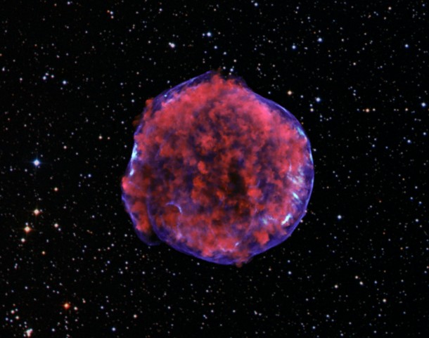 A photograph of the Tycho supernova remnant taken by the Chandra X-ray Observatory. Low-energy X-rays (red) in the image show expanding debris from the supernova explosion and high energy X-rays (blue) show the blast wave, a shell of extremely energetic electrons. X-ray: NASA/CXC/Rutgers/K. Eriksen et al.; Optical (starry background): DSS A photograph of the Tycho supernova remnant taken by the Chandra X-ray Observatory. Low-energy X-rays (red) in the image show expanding debris from the supernova explosion and high energy X-rays (blue) show the blast wave, a shell of extremely energetic electrons. X-ray: NASA/CXC/Rutgers/K. Eriksen et al.; Optical (starry background): DSS