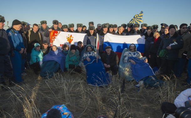 NASA Flight Engineer Karen Nyberg, left, Expedition 37 Commander Fyodor Yurchikhin of Roscosmos, center, and European Space Agency Flight Engineer Luca Parmitano sit in chairs outside the Soyuz capsule just minutes after they landed in Kazakhstan. Image Credit: NASA/Carla Cioffi NASA Flight Engineer Karen Nyberg, left, Expedition 37 Commander Fyodor Yurchikhin of Roscosmos, center, and European Space Agency Flight Engineer Luca Parmitano sit in chairs outside the Soyuz capsule just minutes after they landed in Kazakhstan. Image Credit: NASA/Carla Cioffi