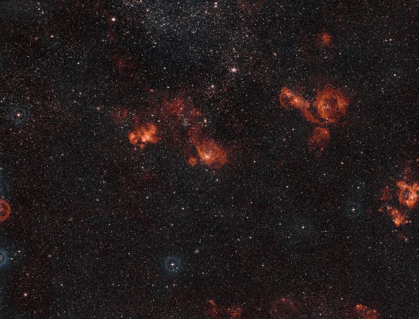 This wide-field view captures several star formations regions in the constellation of Dorado (The Swordfish). These glowing clouds of gas are located in the Large Magellanic Cloud, one of the Milky Way’s satellite galaxies. The bright region a little to the left of centre is NGC 2035. This view was created from images forming part of the Digitized Sky Survey 2. Credit: ESO/Digitized Sky Survey 2. Acknowledgement: Davide De Martin This wide-field view captures several star formations regions in the constellation of Dorado (The Swordfish). These glowing clouds of gas are located in the Large Magellanic Cloud, one of the Milky Way’s satellite galaxies. The bright region a little to the left of centre is NGC 2035. This view was created from images forming part of the Digitized Sky Survey 2. Credit: ESO/Digitized Sky Survey 2. Acknowledgement: Davide De Martin