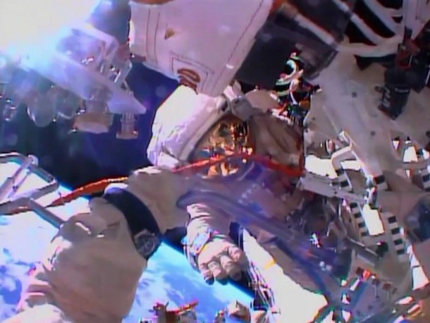 The view from cosmonaut Oleg Kotov's helmet camera shows fellow spacewalker Sergey Ryazanskiy as the two work with an EVA workstation and biaxial pointing platform. Image Credit: NASA TV The view from cosmonaut Oleg Kotov's helmet camera shows fellow spacewalker Sergey Ryazanskiy as the two work with an EVA workstation and biaxial pointing platform. Image Credit: NASA TV