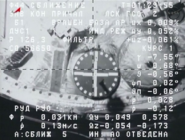 A camera on the ISS Progress 53 cargo ship captured this view of the docking target on the International Space Station as Commander Oleg Kotov manually guided the spacecraft in for docking. Image Credit: NASA TV A camera on the ISS Progress 53 cargo ship captured this view of the docking target on the International Space Station as Commander Oleg Kotov manually guided the spacecraft in for docking. Image Credit: NASA TV