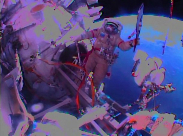 The view from Flight Engineer Sergey Ryazanskiy's helmet camera as Flight Engineer Oleg Kotov waves the Olympic torch outside the International Space Station during Saturday's spacewalk. Image Credit: NASA TV The view from Flight Engineer Sergey Ryazanskiy's helmet camera as Flight Engineer Oleg Kotov waves the Olympic torch outside the International Space Station during Saturday's spacewalk. Image Credit: NASA TV