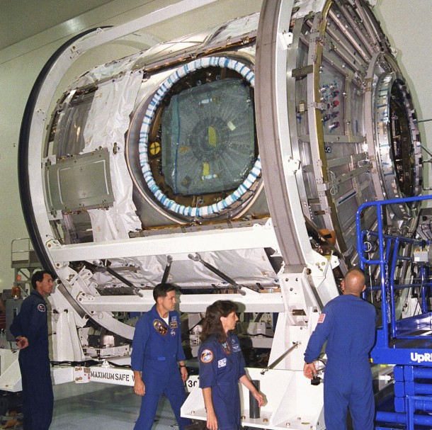 Members of the STS-88 crew examine the Node 1 of the International Space Station in the high bay of the Space Station Processing Facility. Image Credit: NASA Members of the STS-88 crew examine the Node 1 of the International Space Station in the high bay of the Space Station Processing Facility. Image Credit: NASA
