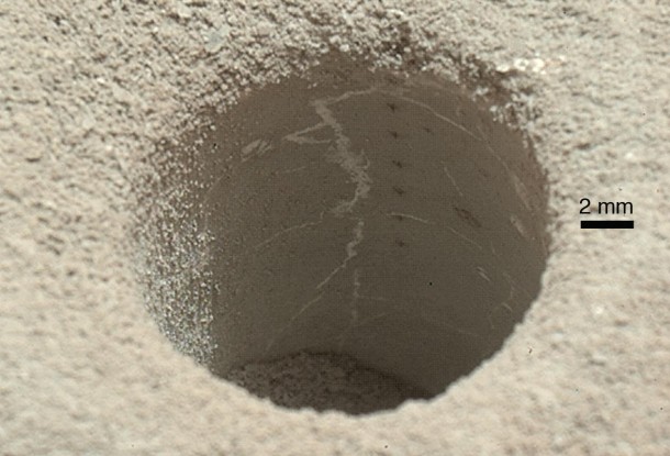 The hole that NASA's Curiosity Mars rover drilled into target rock "John Klein" provided a view into the interior of the rock, as well as obtaining a sample of powdered material from the rock. Image credit: NASA/JPL-Caltech/MSSS The hole that NASA's Curiosity Mars rover drilled into target rock "John Klein" provided a view into the interior of the rock, as well as obtaining a sample of powdered material from the rock. Image credit: NASA/JPL-Caltech/MSSS