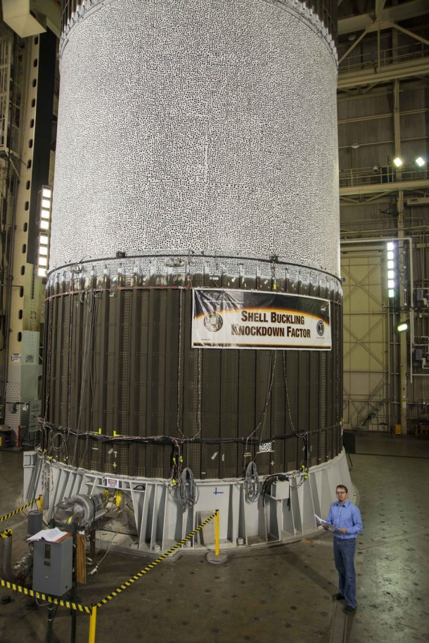 NASA's Mark Hilburger prepares to buckle an aluminum-lithium cylinder about the size of fuel tank barrels for the largest rockets ever built. The black and white dots on the upper portion of the tank helped 20 high-speed cameras record minute changes in the tank as almost a million pounds of force pressed down upon the tank in a test at NASA's Marshall Space Flight Center. Image Credit: NASA/Fred Deaton NASA's Mark Hilburger prepares to buckle an aluminum-lithium cylinder about the size of fuel tank barrels for the largest rockets ever built. The black and white dots on the upper portion of the tank helped 20 high-speed cameras record minute changes in the tank as almost a million pounds of force pressed down upon the tank in a test at NASA's Marshall Space Flight Center. Image Credit: NASA/Fred Deaton