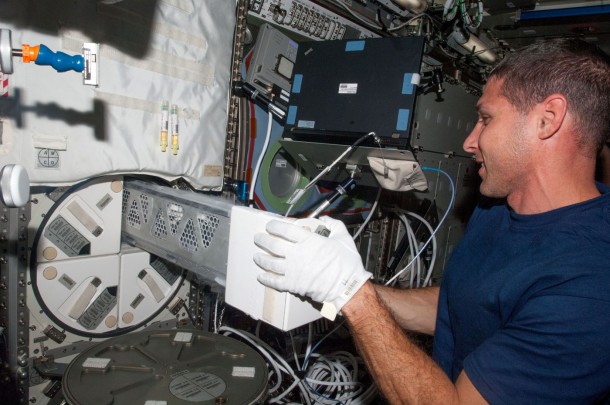 In the International Space Station's Destiny laboratory on Oct. 5, 2013, flight engineer Mike Hopkins removes a dewar tray from the Minus Eighty Laboratory Freezer for ISS in order to insert biological samples into the trays. Image Credit: NASA In the International Space Station's Destiny laboratory on Oct. 5, 2013, flight engineer Mike Hopkins removes a dewar tray from the Minus Eighty Laboratory Freezer for ISS in order to insert biological samples into the trays. Image Credit: NASA