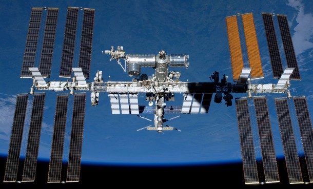 Orbiting by Earth's horizon and the blackness of space, the almost complete International Space Station is featured in this image photographed by an STS-134 crew member of the space shuttle Endeavour on May 29, 2011. At 357 feet end-to-end, it almost spans the 360-foot area of an American football field, including the end zones. With 33,023 cubic feet of pressurized volume the space station now has more livable room than a conventional five-bedroom house. Image Credit: NASA Orbiting by Earth's horizon and the blackness of space, the almost complete International Space Station is featured in this image photographed by an STS-134 crew member of the space shuttle Endeavour on May 29, 2011. At 357 feet end-to-end, it almost spans the 360-foot area of an American football field, including the end zones. With 33,023 cubic feet of pressurized volume the space station now has more livable room than a conventional five-bedroom house. Image Credit: NASA