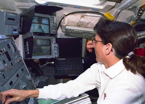 Aided by television monitors, mission specialist Nancy Currie operates the controls of Endeavour's remote manipulator system arm to ease the Russian-built Zarya module onto the U.S.-built Unity connecting module in the shuttle's cargo bay. Image Credit: NASA Aided by television monitors, mission specialist Nancy Currie operates the controls of Endeavour's remote manipulator system arm to ease the Russian-built Zarya module onto the U.S.-built Unity connecting module in the shuttle's cargo bay. Image Credit: NASA