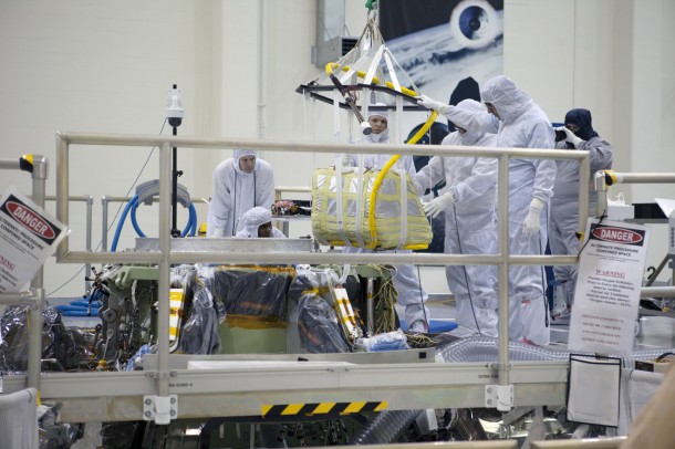A crane lowers the main parachute for installation on the Orion spacecraft inside the Operations and Checkout Building high bay at NASA’s Kennedy Space Center in Florida. Image Credit: NASA/Kim Shiflett A crane lowers the main parachute for installation on the Orion spacecraft inside the Operations and Checkout Building high bay at NASA’s Kennedy Space Center in Florida. Image Credit: NASA/Kim Shiflett