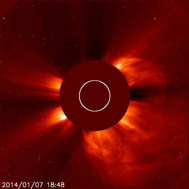 A giant cloud of solar particles, called a coronal mass ejection, explodes off the sun on Jan. 7, 2014, as seen in the light halo to the lower right in this image captured by ESA/NASA's Solar and Heliospheric Observatory. The sun is obscured to better see the tenuous atmosphere around it. Image Credit: ESA/NASA/SOHO A giant cloud of solar particles, called a coronal mass ejection, explodes off the sun on Jan. 7, 2014, as seen in the light halo to the lower right in this image captured by ESA/NASA's Solar and Heliospheric Observatory. The sun is obscured to better see the tenuous atmosphere around it. Image Credit: ESA/NASA/SOHO