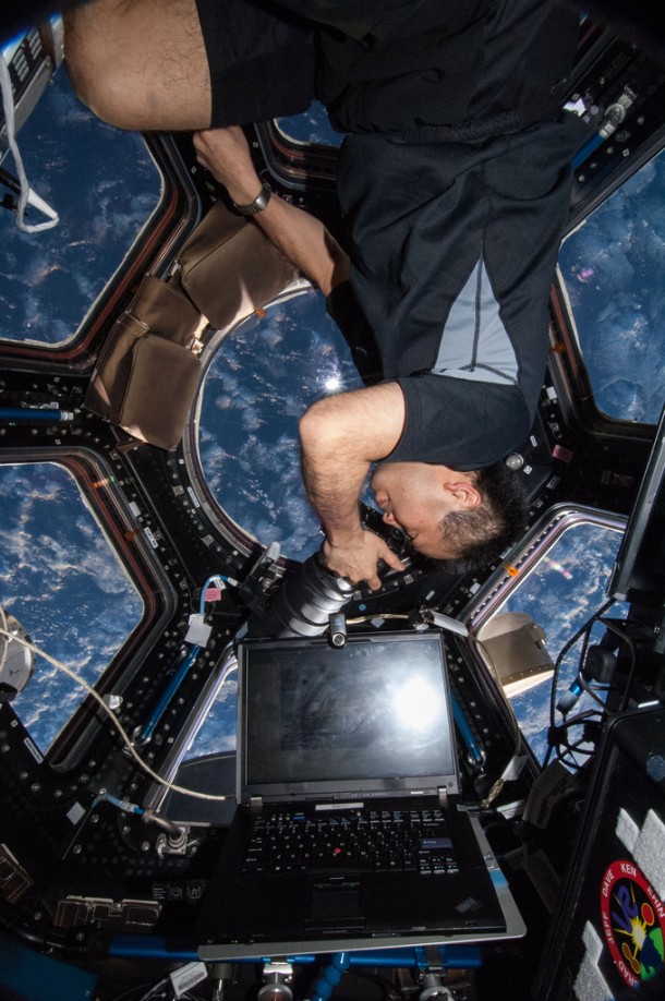 Japan Aerospace Exploration Agency astronaut Koichi Wakata, Expedition 38 flight engineer, uses a still camera to photograph the topography of a point on Earth from a window in the cupola of the International Space Station. Image Credit: NASA Japan Aerospace Exploration Agency astronaut Koichi Wakata, Expedition 38 flight engineer, uses a still camera to photograph the topography of a point on Earth from a window in the cupola of the International Space Station. Image Credit: NASA