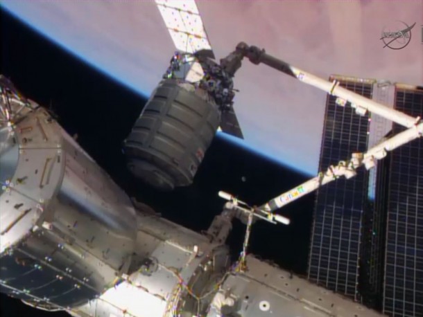The Cygnus resupply craft is attached to the Canadarm2 while being guided to the Harmony node for installation. Image Credit: NASA TV The Cygnus resupply craft is attached to the Canadarm2 while being guided to the Harmony node for installation. Image Credit: NASA TV