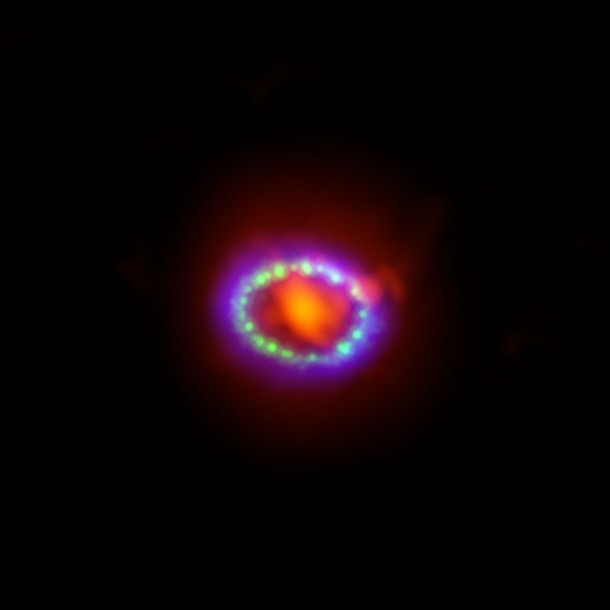 This image shows the remnant of Supernova 1987A seen in light of very different wavelengths. ALMA data (in red) shows newly formed dust in the centre of the remnant. Hubble (in green) and Chandra (in blue) data show the expanding shock wave. Credit: ALMA (ESO/NAOJ/NRAO)/A. Angelich. Visible light image: the NASA/ESA Hubble Space Telescope. X-Ray image: The NASA Chandra X-Ray Observatory This image shows the remnant of Supernova 1987A seen in light of very different wavelengths. ALMA data (in red) shows newly formed dust in the centre of the remnant. Hubble (in green) and Chandra (in blue) data show the expanding shock wave. Credit: ALMA (ESO/NAOJ/NRAO)/A. Angelich. Visible light image: the NASA/ESA Hubble Space Telescope. X-Ray image: The NASA Chandra X-Ray Observatory