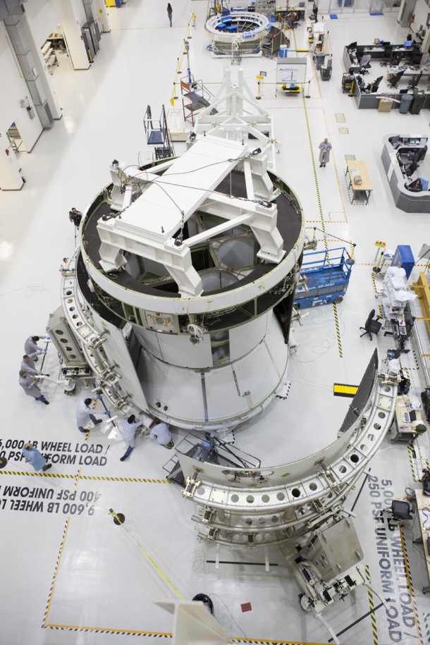 The fairings that will protect it during launch are added to Orion’s service module at the Operations and Checkout facility at Kennedy Space Center. Image Credit: NASA The fairings that will protect it during launch are added to Orion’s service module at the Operations and Checkout facility at Kennedy Space Center. Image Credit: NASA
