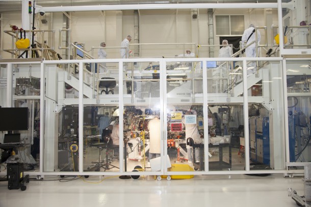 Engineers work on Orion’s crew module inside a temporary clean room set up inside the Operations and Checkout facility at Kennedy Space Center. Welding on the crew module was completed this month. Image Credit: NASA Engineers work on Orion’s crew module inside a temporary clean room set up inside the Operations and Checkout facility at Kennedy Space Center. Welding on the crew module was completed this month. Image Credit: NASA