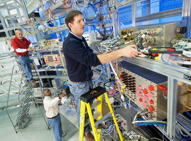 From left, Wayne Arrington, Gerald Clayton and Ryan MacKrell, all of The Boeing Company, work on setting up the avionics system in flight configuration in the Systems Integration and Test Facility at NASA's Marshall Space Flight Center. Image Credit: Boeing From left, Wayne Arrington, Gerald Clayton and Ryan MacKrell, all of The Boeing Company, work on setting up the avionics system in flight configuration in the Systems Integration and Test Facility at NASA's Marshall Space Flight Center. Image Credit: Boeing