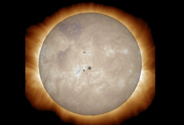Two images of the sun from NASA's SDO are combined: The large sunspot near the center of the sun is part of an active region that produced a mid-strength solar flare on Jan. 7, 2014. An outline of the flare can be seen in the overlay. The sunspot group is some seven Earth's across. Image Credit: NASA/SDO Two images of the sun from NASA's SDO are combined: The large sunspot near the center of the sun is part of an active region that produced a mid-strength solar flare on Jan. 7, 2014. An outline of the flare can be seen in the overlay. The sunspot group is some seven Earth's across. Image Credit: NASA/SDO