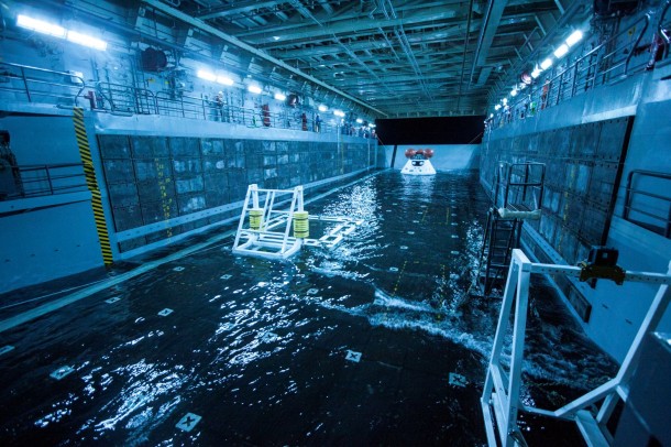 A test version of the Orion spacecraft is tethered inside the well deck of the USS San Diego prior to testing between NASA and the U.S. Navy. To safely bring Orion home after splashdown, it will be towed into the flooded well deck and secured in a special cradle before the water is drained. A test version of the Orion spacecraft is tethered inside the well deck of the USS San Diego prior to testing between NASA and the U.S. Navy. To safely bring Orion home after splashdown, it will be towed into the flooded well deck and secured in a special cradle before the water is drained.