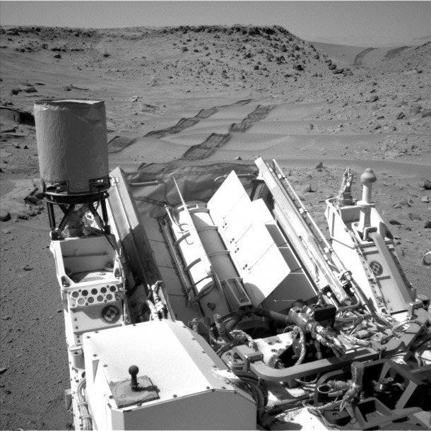 NASA's Curiosity Mars rover used the Navigation Camera (Navcam) on its mast to catch this look-back eastward at wheel tracks from driving through and past "Dingo Gap" inside Gale Crater. Image Credit: NASA/JPL-Caltech NASA's Curiosity Mars rover used the Navigation Camera (Navcam) on its mast to catch this look-back eastward at wheel tracks from driving through and past "Dingo Gap" inside Gale Crater. Image Credit: NASA/JPL-Caltech