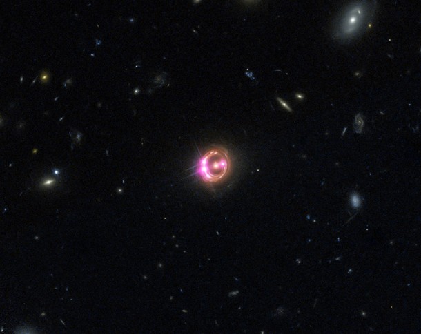 Multiple images of a distant quasar known as RX J1131-1231 are visible in this combined view from Chandra (pink) and Hubble (red, green, and blue). Image Credit: NASA/CXC/Univ of Michigan/R.C.Reis et al; Optical: NASA/STSc Multiple images of a distant quasar known as RX J1131-1231 are visible in this combined view from Chandra (pink) and Hubble (red, green, and blue). Image Credit: NASA/CXC/Univ of Michigan/R.C.Reis et al; Optical: NASA/STSc