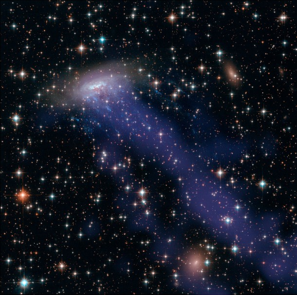This image combines NASA/ESA Hubble Space Telescope observations with data from the Chandra X-ray Observatory. As well as the electric blue ram pressure stripping streaks seen emanating from ESO 137-001, a giant gas stream can be seen extending towards the bottom of the frame, only visible in the X-ray part of the spectrum. Credit: NASA, ESA, CXC This image combines NASA/ESA Hubble Space Telescope observations with data from the Chandra X-ray Observatory. As well as the electric blue ram pressure stripping streaks seen emanating from ESO 137-001, a giant gas stream can be seen extending towards the bottom of the frame, only visible in the X-ray part of the spectrum. Credit: NASA, ESA, CXC