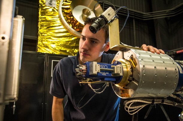 RROxiTT lead roboticist Alex Janas stands with the Oxidizer Nozzle Tool as he examines the work site. Image Credit: NASA/Chris Gunn RROxiTT lead roboticist Alex Janas stands with the Oxidizer Nozzle Tool as he examines the work site. Image Credit: NASA/Chris Gunn