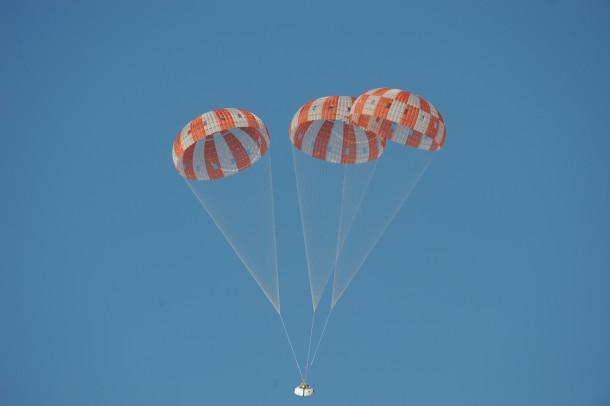 A test version of Orion descends under its three massive main parachutes, which together would cover almost all of a football field. Image Credit: NASA A test version of Orion descends under its three massive main parachutes, which together would cover almost all of a football field. Image Credit: NASA
