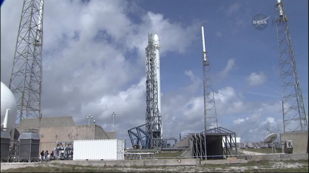 The SpaceX Falcon 9 that will carry the Dragon cargo craft into orbit awaits its launch at Launch Complex 40 at the Cape Canaveral Air Force Station, Fla. Image Credit: NASA TV The SpaceX Falcon 9 that will carry the Dragon cargo craft into orbit awaits its launch at Launch Complex 40 at the Cape Canaveral Air Force Station, Fla. Image Credit: NASA TV