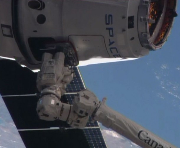 The SpaceX Dragon cargo vehicle is grappled by the International Space Station's robotic arm. Image Credit: NASA TV The SpaceX Dragon cargo vehicle is grappled by the International Space Station's robotic arm. Image Credit: NASA TV