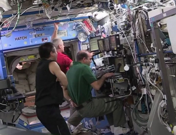 At a robotics workstation in the station's Destiny lab, Flight Engineer Rick Mastracchio (right) participates in Common Berthing Mechanism operations for the SpaceX Dragon, while Flight Engineer Steve Swanson (center) and Commander Koichi Wakata look on. Image Credit: NASA TV At a robotics workstation in the station's Destiny lab, Flight Engineer Rick Mastracchio (right) participates in Common Berthing Mechanism operations for the SpaceX Dragon, while Flight Engineer Steve Swanson (center) and Commander Koichi Wakata look on. Image Credit: NASA TV