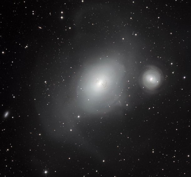 This new image from the MPG/ESO 2.2-metre telescope at ESO’s La Silla Observatory in Chile shows a contrasting pair of galaxies: NGC 1316, and its smaller companion NGC 1317 (right). Although NGC 1317 seems to have had a peaceful existence, its larger neighbour bears the scars of earlier mergers with other galaxies. Credit: ESO This new image from the MPG/ESO 2.2-metre telescope at ESO’s La Silla Observatory in Chile shows a contrasting pair of galaxies: NGC 1316, and its smaller companion NGC 1317 (right). Although NGC 1317 seems to have had a peaceful existence, its larger neighbour bears the scars of earlier mergers with other galaxies. Credit: ESO
