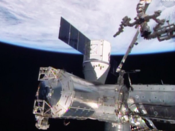 The Canadarm2 with Dextre in its grasp is in the middle of removing external cargo from the SpaceX Dragon commercial cargo craft. Image Credit: NASA TV The Canadarm2 with Dextre in its grasp is in the middle of removing external cargo from the SpaceX Dragon commercial cargo craft. Image Credit: NASA TV