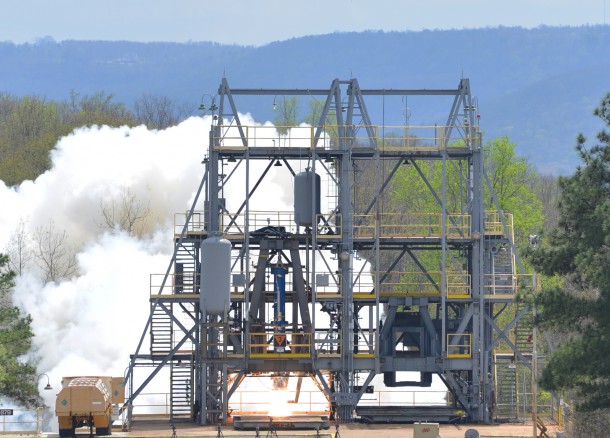 A subscale solid rocket motor blazed to life producing 50,000 pounds of thrust during a vertical test firing at the Redstone Test Center’s Test Area 5 on Redstone Arsenal in Huntsville, Ala. Image Credit: Redstone Test Center) A subscale solid rocket motor blazed to life producing 50,000 pounds of thrust during a vertical test firing at the Redstone Test Center’s Test Area 5 on Redstone Arsenal in Huntsville, Ala. Image Credit: Redstone Test Center)