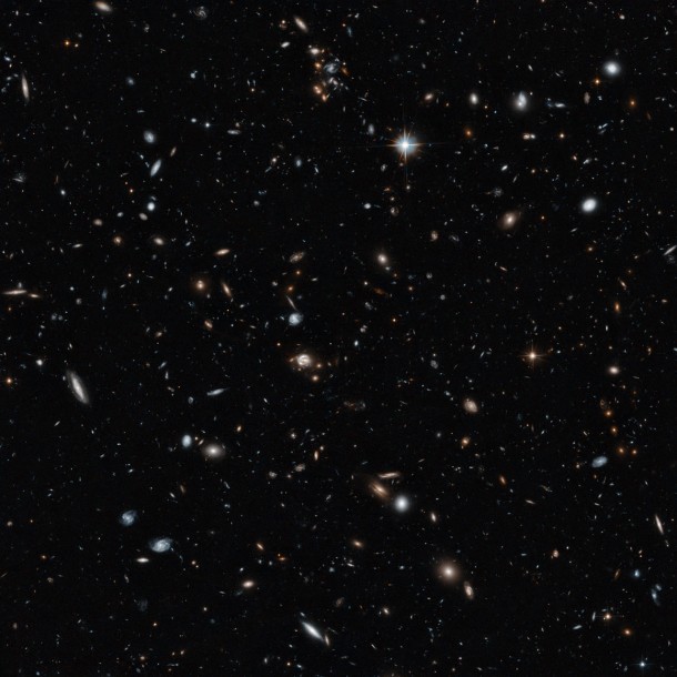An image of a galaxy cluster taken by the NASA/ESA Hubble Space Telescope gives a remarkable cross-section of the Universe, showing objects at different distances and stages in cosmic history. They range from cosmic near neighbours to objects seen in the early years of the Universe. The 14-hour exposure shows objects around a billion times fainter than can be seen with the naked eye. Credit: NASA, ESA An image of a galaxy cluster taken by the NASA/ESA Hubble Space Telescope gives a remarkable cross-section of the Universe, showing objects at different distances and stages in cosmic history. They range from cosmic near neighbours to objects seen in the early years of the Universe. The 14-hour exposure shows objects around a billion times fainter than can be seen with the naked eye. Credit: NASA, ESA