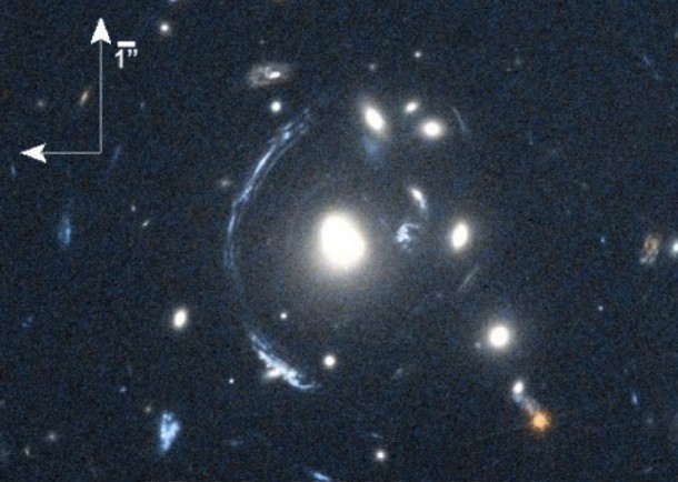 The young galaxy SDSS090122.37+181432.3, also known as S0901, is seen here as the bright arc to the left of the central bright galaxy. Image Credit: NASA/STScI; S. Allam, L. Moustakas, K. Stewart The young galaxy SDSS090122.37+181432.3, also known as S0901, is seen here as the bright arc to the left of the central bright galaxy. Image Credit: NASA/STScI; S. Allam, L. Moustakas, K. Stewart