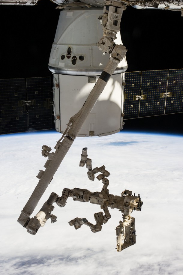 Backdropped against a cloudy portion of Earth, the Special Purpose Dexterous Manipulator -- the Canadian Space Agency's robotic "handyman" -- and Canadarm2 take a "rest" after completing a task 225 miles above the home planet. Image Credit: NASA Backdropped against a cloudy portion of Earth, the Special Purpose Dexterous Manipulator -- the Canadian Space Agency's robotic "handyman" -- and Canadarm2 take a "rest" after completing a task 225 miles above the home planet. Image Credit: NASA