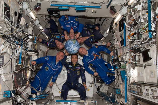 Expedition 39 crew members pose around a globe inside the Kibo laboratory as the International Space Station orbits around the Earth. Expedition 39 crew members pose around a globe inside the Kibo laboratory as the International Space Station orbits around the Earth.
