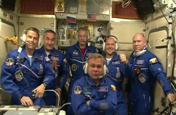 The Expedition 40 crew gathers in the International Space Station's Zvezda service module to receive congratulatory calls for the three newest crew members. Image Credit: NASA TV The Expedition 40 crew gathers in the International Space Station's Zvezda service module to receive congratulatory calls for the three newest crew members. Image Credit: NASA TV