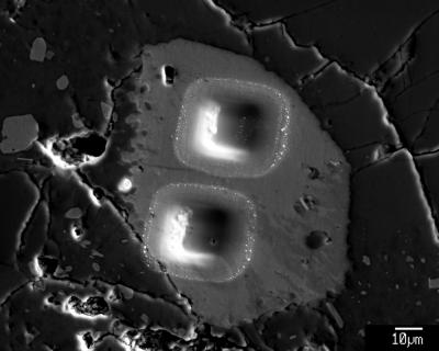 This shows secondary electron image of pits left by ion microprobe analyses of a heterogeneous apatite grain in Apollo sample 14321, 1047. Water has now been detected in apatite in many different lunar rock types. Credit: Katharine L. Robinson, University of Hawaii, HIGP This shows secondary electron image of pits left by ion microprobe analyses of a heterogeneous apatite grain in Apollo sample 14321, 1047. Water has now been detected in apatite in many different lunar rock types. Credit: Katharine L. Robinson, University of Hawaii, HIGP