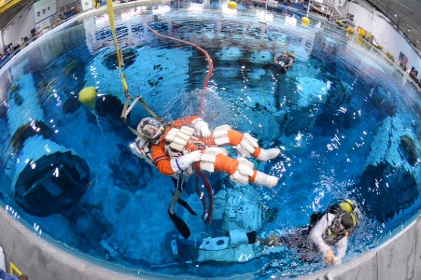 Steve Bowen is lowered into the Neutral Buoyancy Laboratory at Johnson Space Center to test spacewalk suits and tools for a mission to an asteroid. Image Credit: NASA Steve Bowen is lowered into the Neutral Buoyancy Laboratory at Johnson Space Center to test spacewalk suits and tools for a mission to an asteroid. Image Credit: NASA