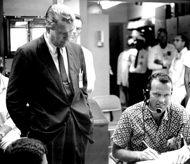 Marshall Space Flight Center Director Wernher von Braun looks on as Gordon Cooper serves as capsule communicator, or cap comm, for Alan Shepard's Mercury Redstone-3 countdown in the blockhouse at Cape Canaveral Air Force Station's Launch Pad 5. Astronauts serve as "cap. Comms." to facilitate only one voice speaking to the spacecraft pilots. Image Credit: NASA Marshall Space Flight Center Director Wernher von Braun looks on as Gordon Cooper serves as capsule communicator, or cap comm, for Alan Shepard's Mercury Redstone-3 countdown in the blockhouse at Cape Canaveral Air Force Station's Launch Pad 5. Astronauts serve as "cap. Comms." to facilitate only one voice speaking to the spacecraft pilots. Image Credit: NASA