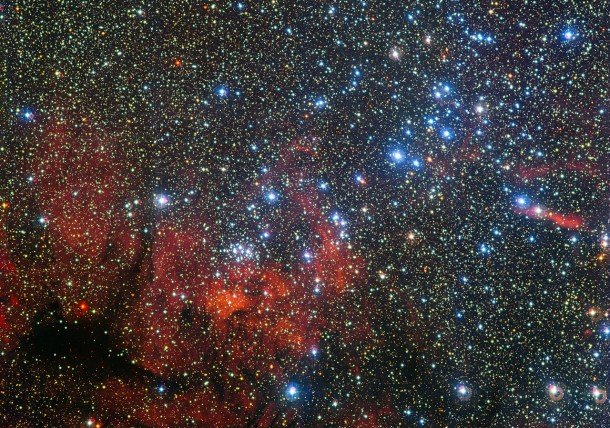 This colourful new image from the MPG/ESO 2.2-metre telescope at ESO's La Silla Observatory in Chile shows the star cluster NGC 3590. These stars shine brightly in front of a dramatic landscape of dark patches of dust and richly hued clouds of glowing gas. This small stellar gathering gives astronomers clues about how these stars form and evolve — as well as giving hints about the structure of our galaxy's pinwheeling arms. Credit: ESO/G. Beccari This colourful new image from the MPG/ESO 2.2-metre telescope at ESO's La Silla Observatory in Chile shows the star cluster NGC 3590. These stars shine brightly in front of a dramatic landscape of dark patches of dust and richly hued clouds of glowing gas. This small stellar gathering gives astronomers clues about how these stars form and evolve — as well as giving hints about the structure of our galaxy's pinwheeling arms. Credit: ESO/G. Beccari